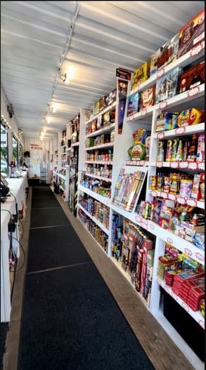 Clean organized shelving inside a Pooter's Fireworks seasonal retail stand